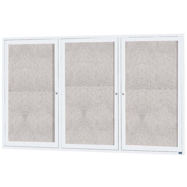A white Aarco enclosed bulletin board cabinet with three white doors and windows.