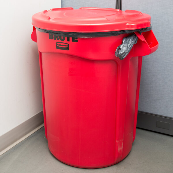 A Rubbermaid red trash can with a lid on it.