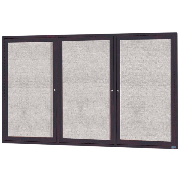 A white rectangular Aarco bulletin board cabinet with three glass doors with black frames.