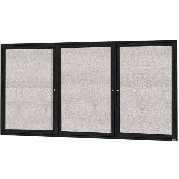 A white rectangular bulletin board cabinet with black trim and three glass doors.