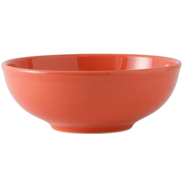 A Tuxton Cinnebar bowl with a white background and red rim.