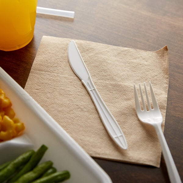A beige napkin with a white plastic knife on it.
