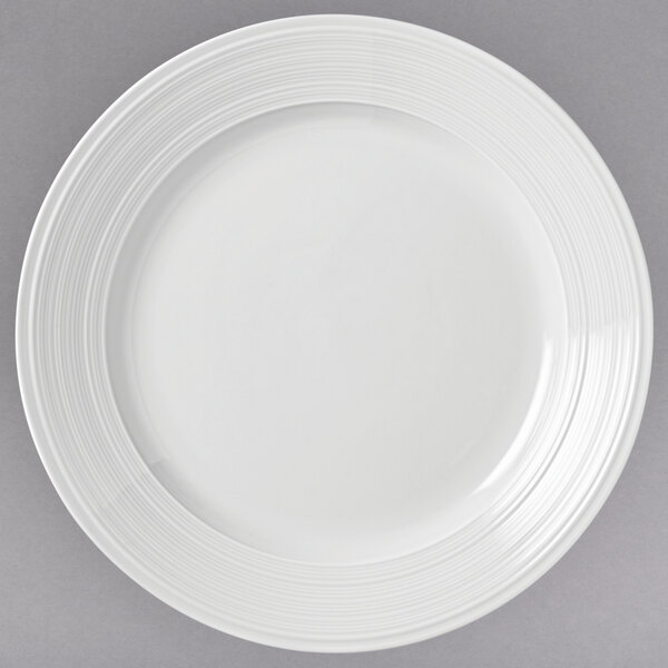 A close-up of a white Libbey Galileo porcelain plate with a circular design.