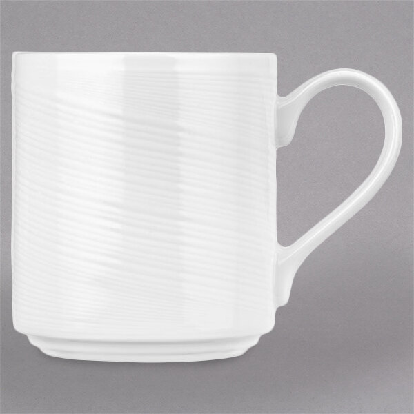 A white Royal Rideau porcelain mug with a wavy design on the handle.