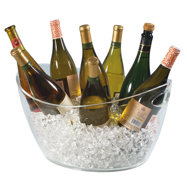 A Franmara clear acrylic oval wine bucket filled with bottles of wine on ice.