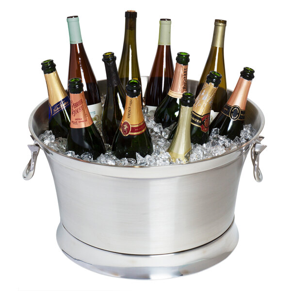 A Franmara Cornucopia double wall cooler filled with wine bottles on a table in a winery cellar.