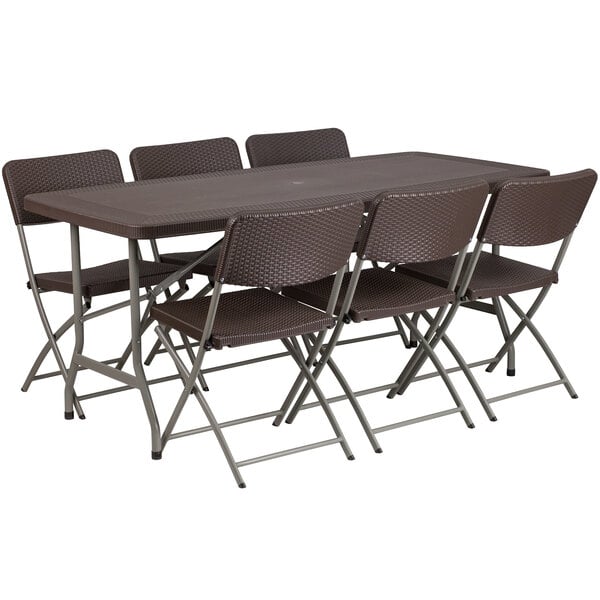 A brown plastic folding table with six chairs set up outdoors.