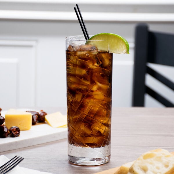 A Reserve by Libbey Crosshatch beverage glass filled with ice tea on a table.