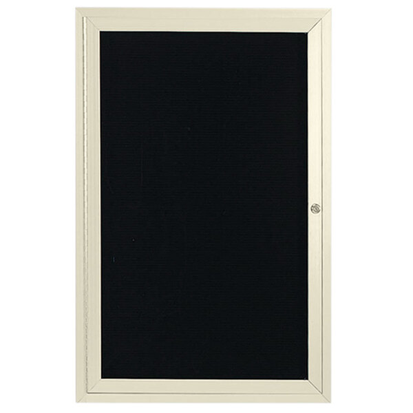 An ivory enclosed door with a black frame holding a black and white letter board.
