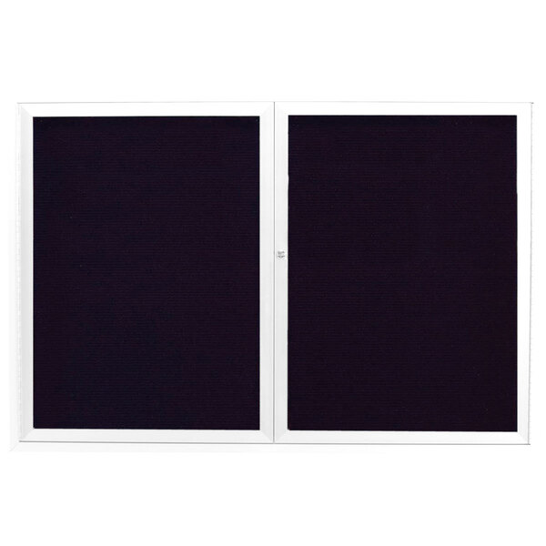 Two white rectangular Aarco bulletin boards with black trim and white letter boards inside.