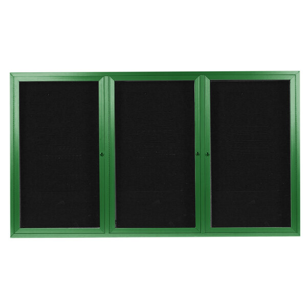 A green rectangular directory board with three black-framed black letter boards.