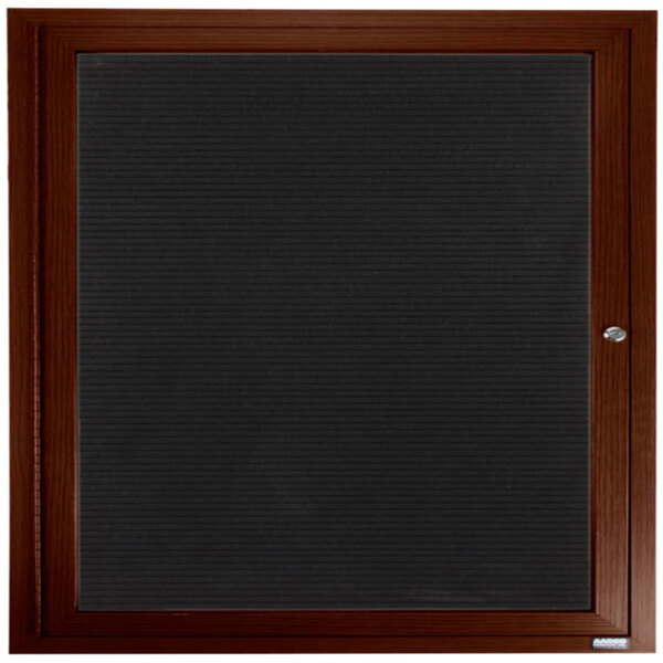 An Aarco walnut indoor directory board with a wooden frame.