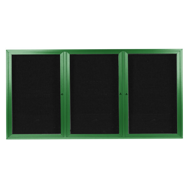 A green rectangular bulletin board with black trim and three doors with black letter boards inside.