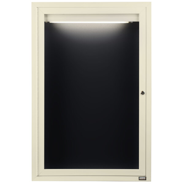A white framed door with a black board and light.