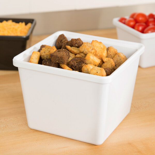 A white square melamine crock with food in it.