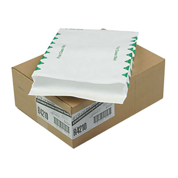 A brown box with green and white labels containing white U.S. Postal Service expansion mailers.