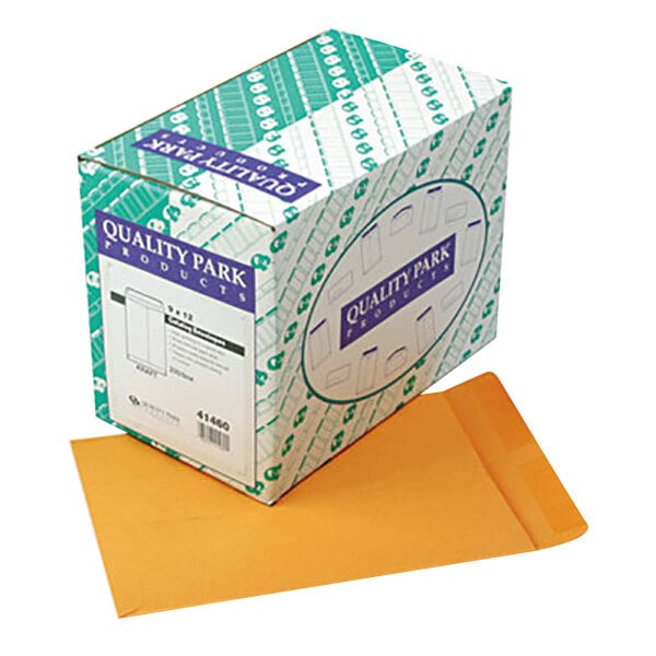A box of Quality Park brown kraft file envelopes with a blue and white label.