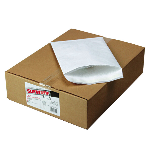 A brown box with a white Survivor Tyvek bubble mailer inside.