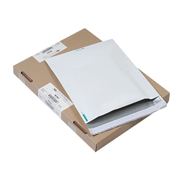 A white envelope on top of a brown box.