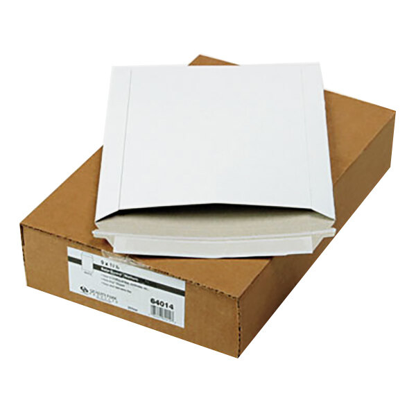 A brown box with white Quality Park photo/document mailers on top.