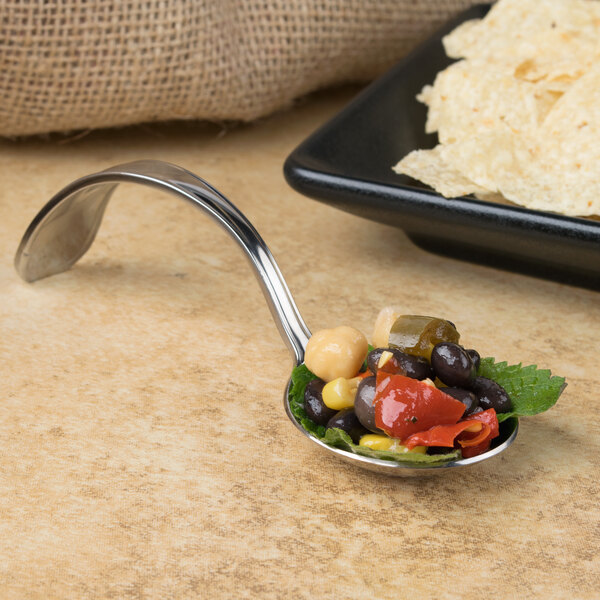 A Bon Chef curved metal bouillon spoon with food in it.