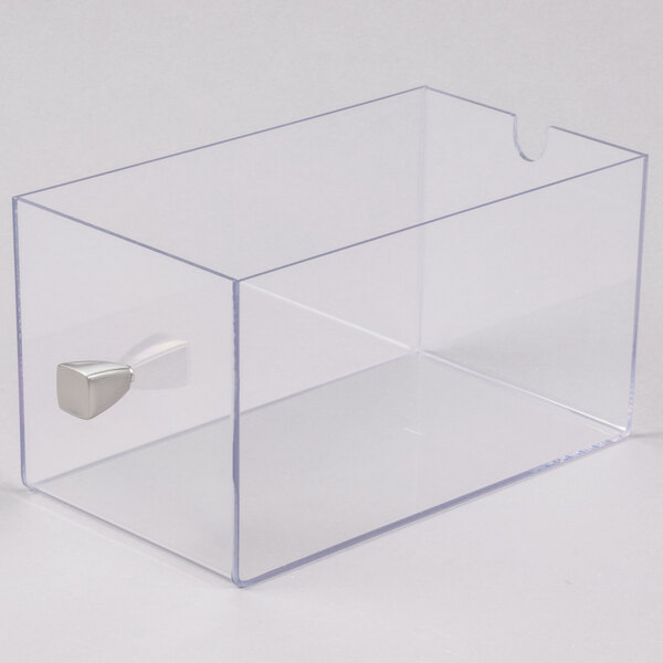 A clear plastic container with a silver handle.