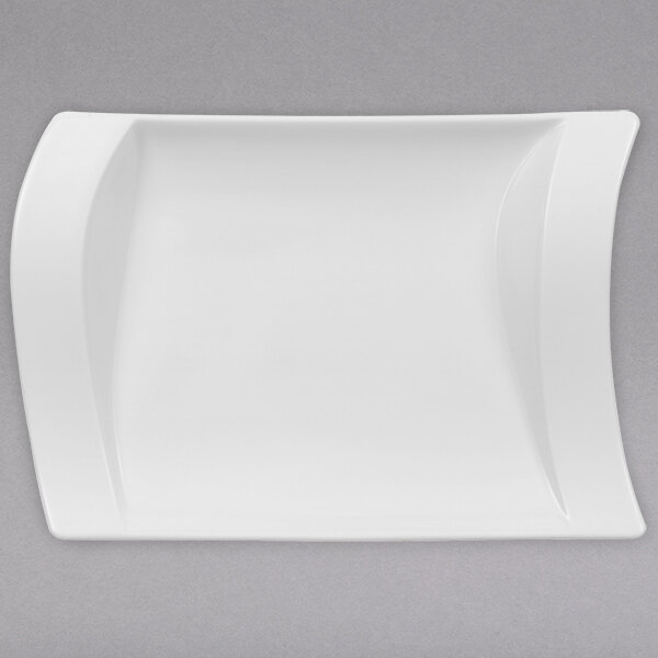 A Villeroy & Boch NewWave white porcelain pickle dish with a curved edge.