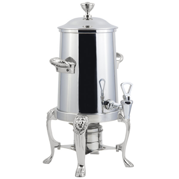 A Bon Chef stainless steel coffee chafer urn with a lion head and chrome trim on a stand.