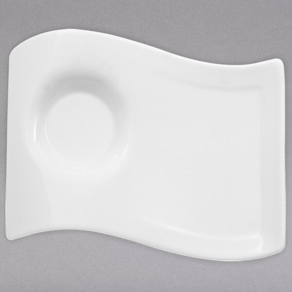 A Villeroy & Boch white porcelain party plate with a curved edge.