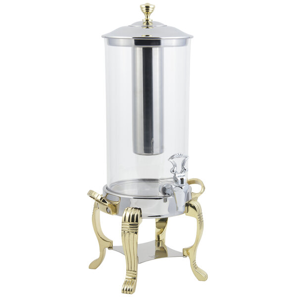 A glass beverage dispenser with a gold base and silver accents.