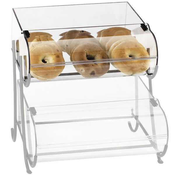 A clear acrylic bin in a glass display case with a group of bagels.