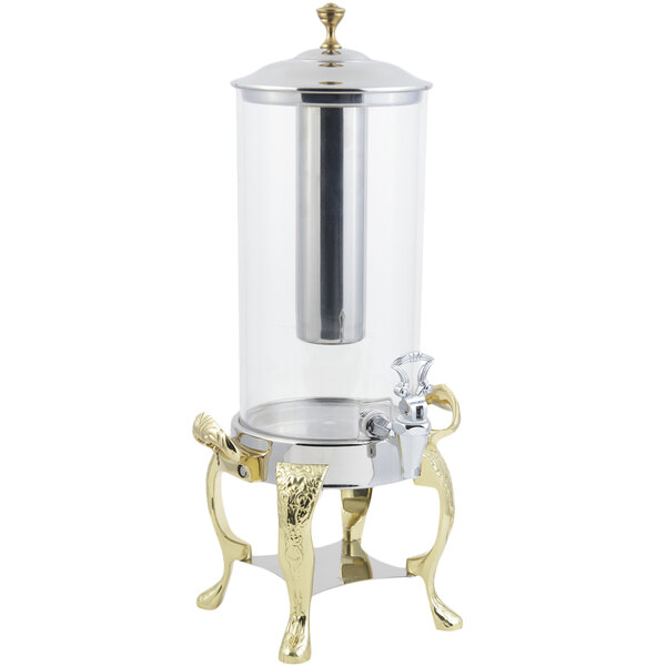 A Bon Chef brass beverage dispenser with a stainless steel ice chamber on a counter.