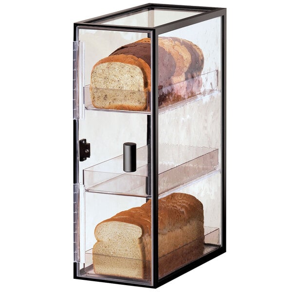 A glass Cal-Mil bakery display case with three tiers holding loaves of bread.