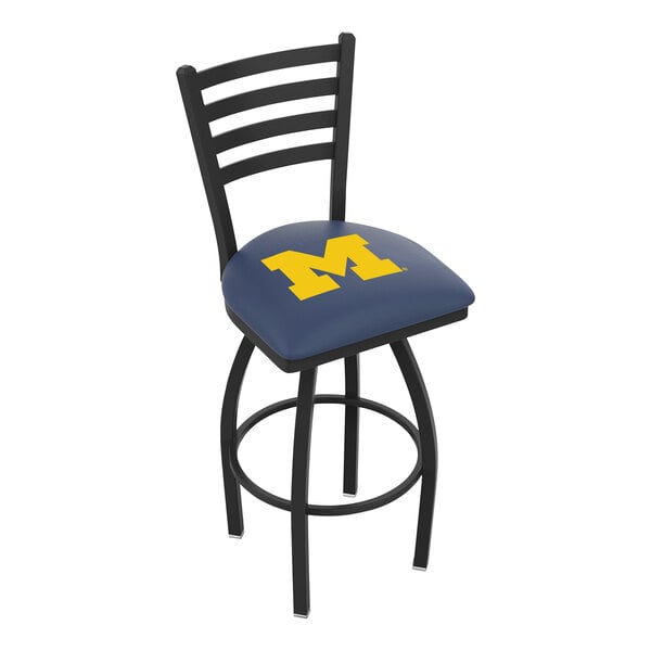 A blue and black Holland Bar Stool with the University of Michigan logo on the padded seat and ladder back.