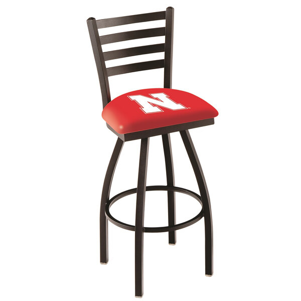 A black bar stool with a red padded seat and backrest with the University of Nebraska logo.