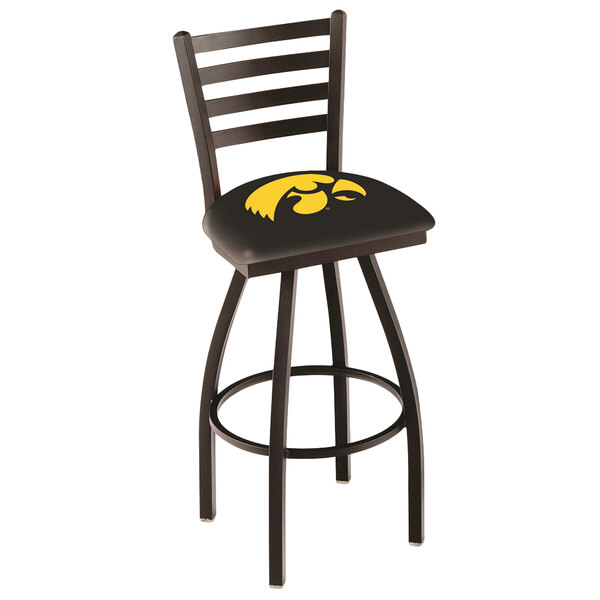 A Holland Bar Stool University of Iowa swivel stool with ladder back and black padded seat with a yellow and black Iowa logo.