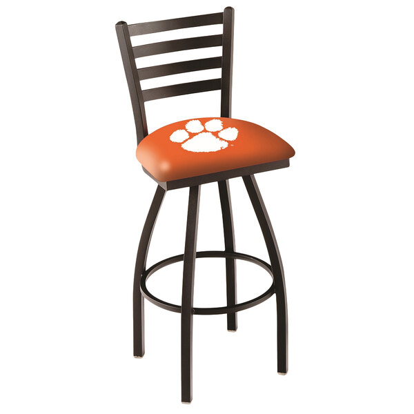 A Holland Bar Stool with a ladder back and orange padded seat with a Clemson University paw print.