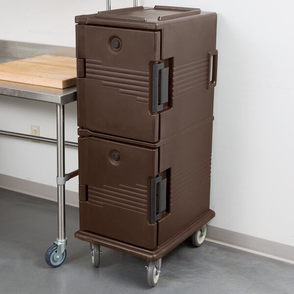 A brown plastic Cambro Ultra Camcart food pan carrier with wheels and a door.