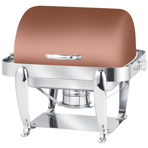 A copper and stainless steel rectangular roll top chafer on a table outdoors.