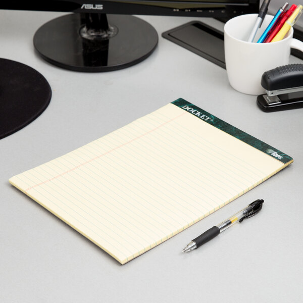 A TOPS Docket notepad and pen on a table.