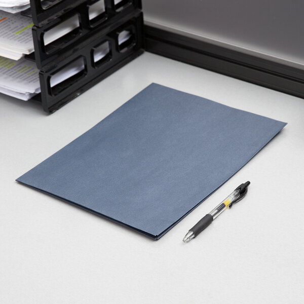 A blue Oxford 2-pocket folder next to a pen on a desk.