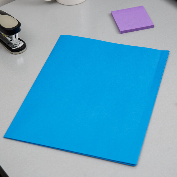 A light blue Oxford 2-pocket folder on a table.