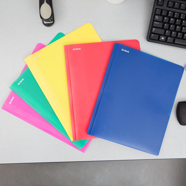A group of Oxford 2-pocket plastic folders in assorted colors.