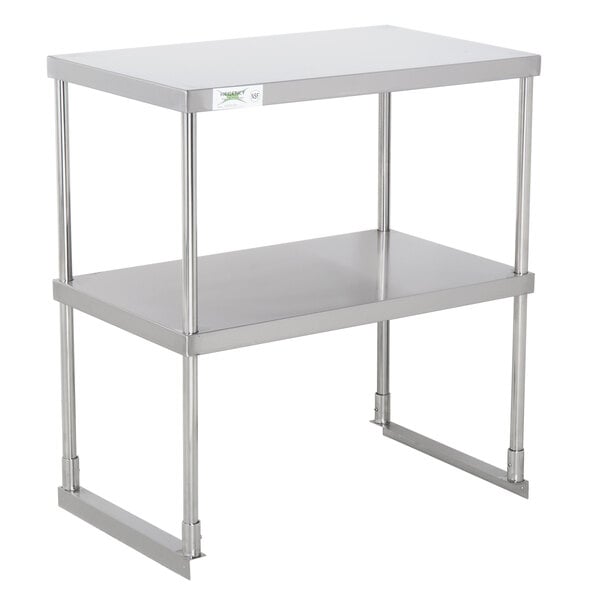 A Regency stainless steel double deck overshelf on a table with two shelves.