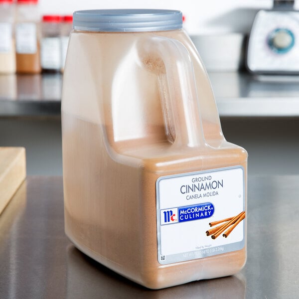 A large container of McCormick Culinary Ground Cinnamon.