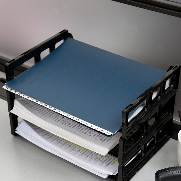 A dark blue Pendaflex desk file with letters on it.