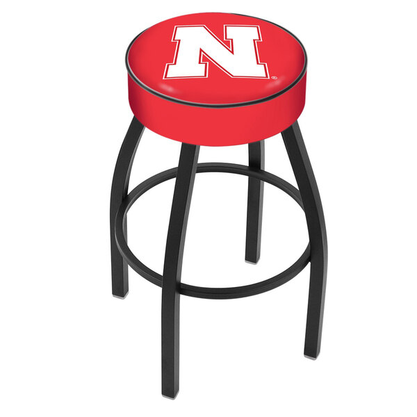 A red Holland Bar Stool with University of Nebraska logo on the seat and black legs.