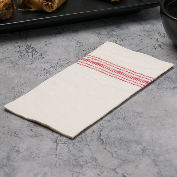 A white Hoffmaster dinner napkin with red dishtowel print stripes.