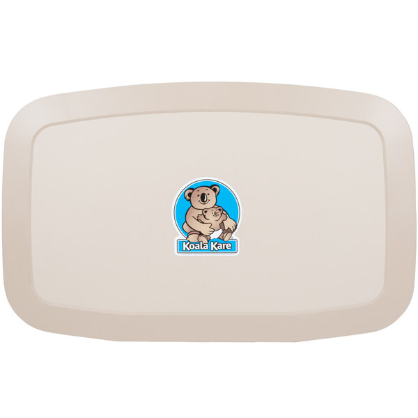 A white plastic baby changing station with a cartoon of a koala bear and a blue circle.