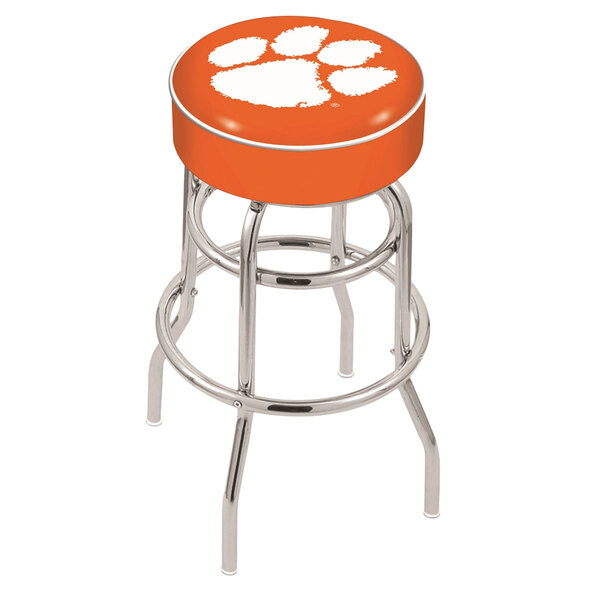 A Holland Bar Stool with a Clemson University paw print on an orange seat and chrome base.